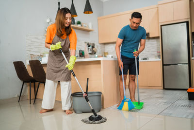 Side view of young woman standing on floor