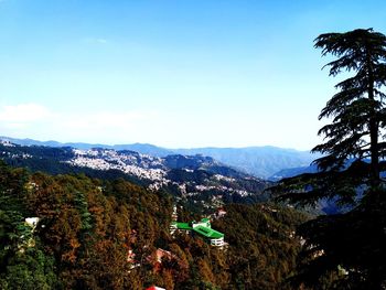 Scenic view of trees and mountains against sky