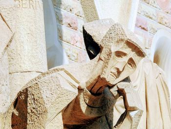 Low angle view of statue against wall