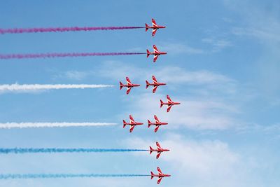 Low angle view of airplane flying against sky