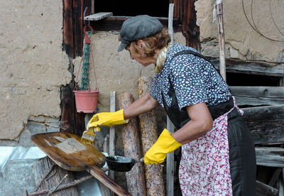 Woman painting on wood