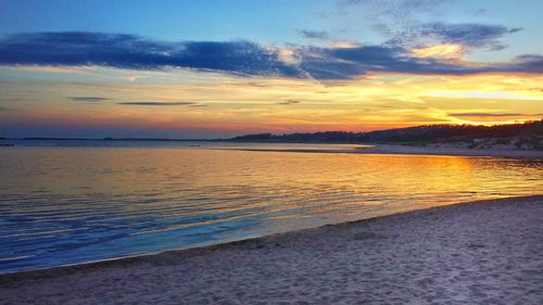 Scenic view of beach against sky during sunset