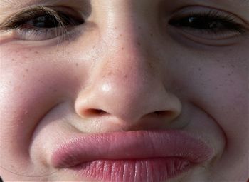 Full frame portrait of girl puckering outdoors