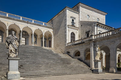 Low angle view of historic building against clear blue sky