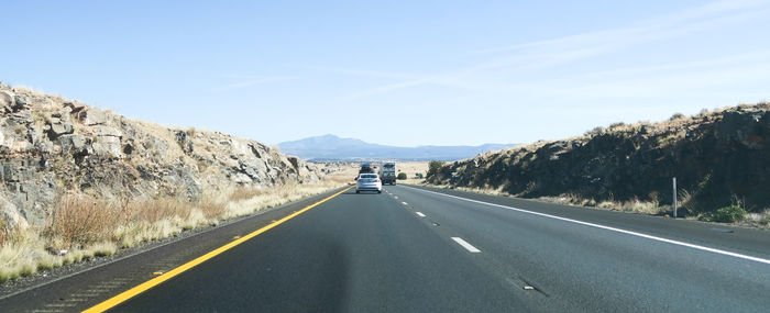 Cars on road against sky