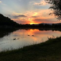 Scenic view of lake against sky during sunset