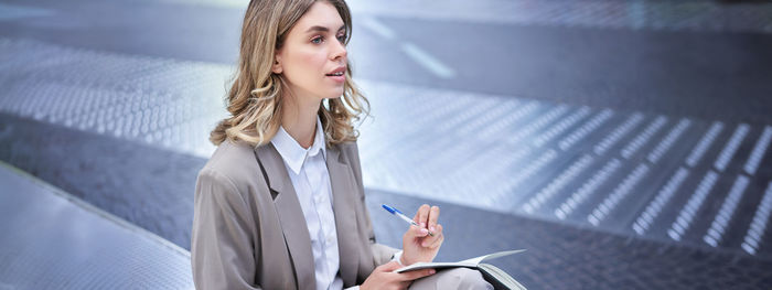 Portrait of young woman using mobile phone