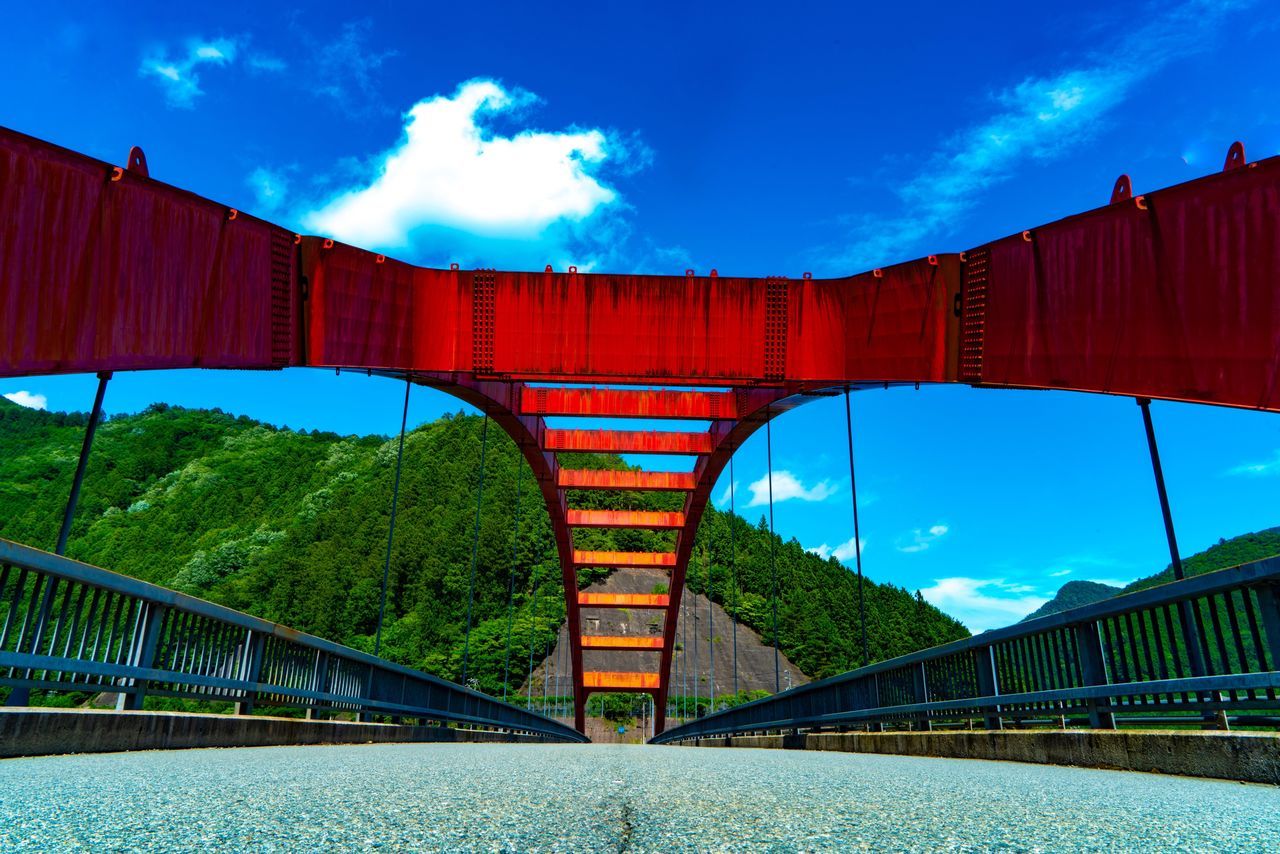 connection, bridge, sky, bridge - man made structure, architecture, built structure, red, transportation, cloud - sky, engineering, nature, plant, arch, day, tree, water, railing, blue, mountain, outdoors, arch bridge