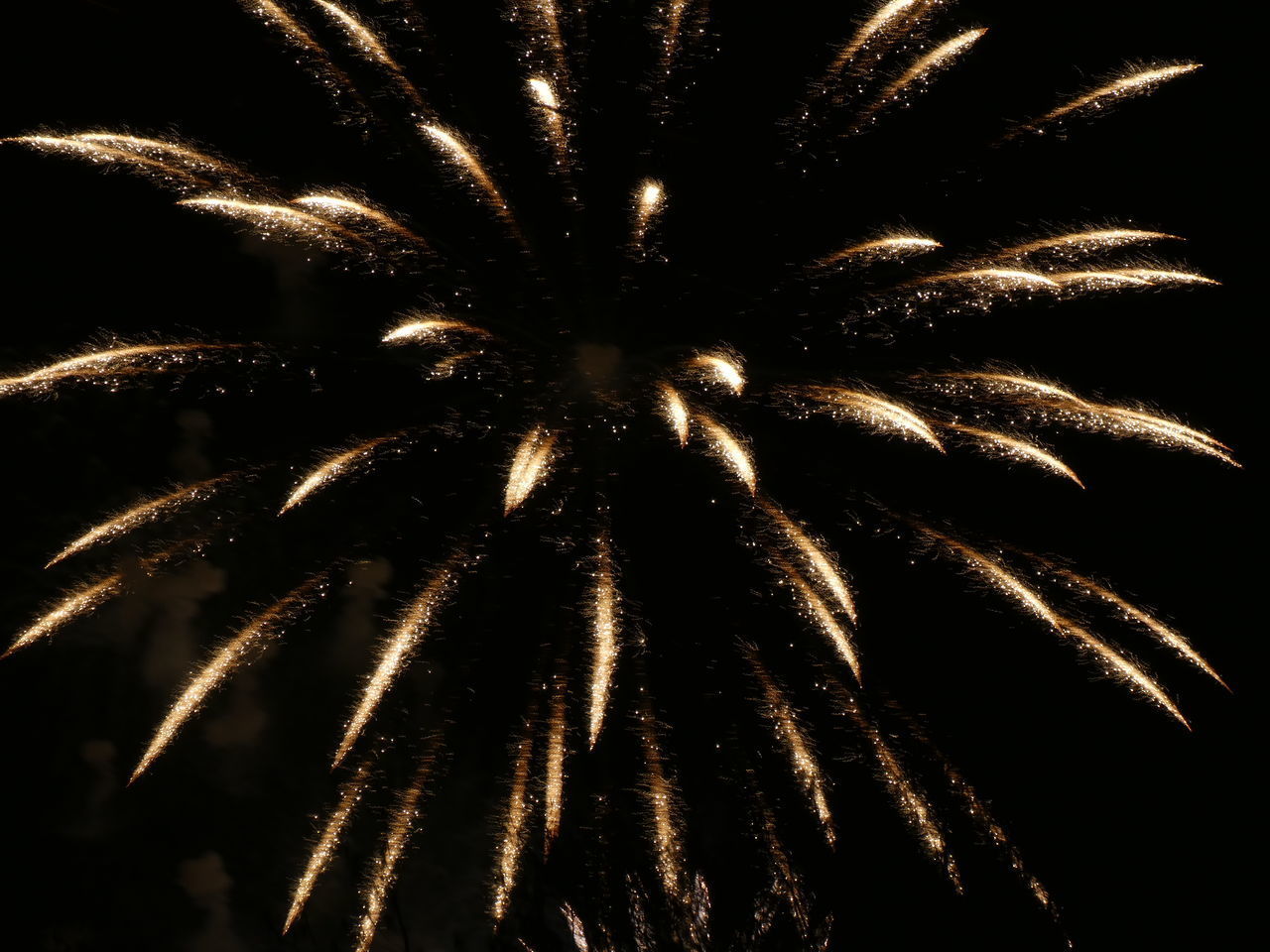 LOW ANGLE VIEW OF FIREWORKS IN SKY