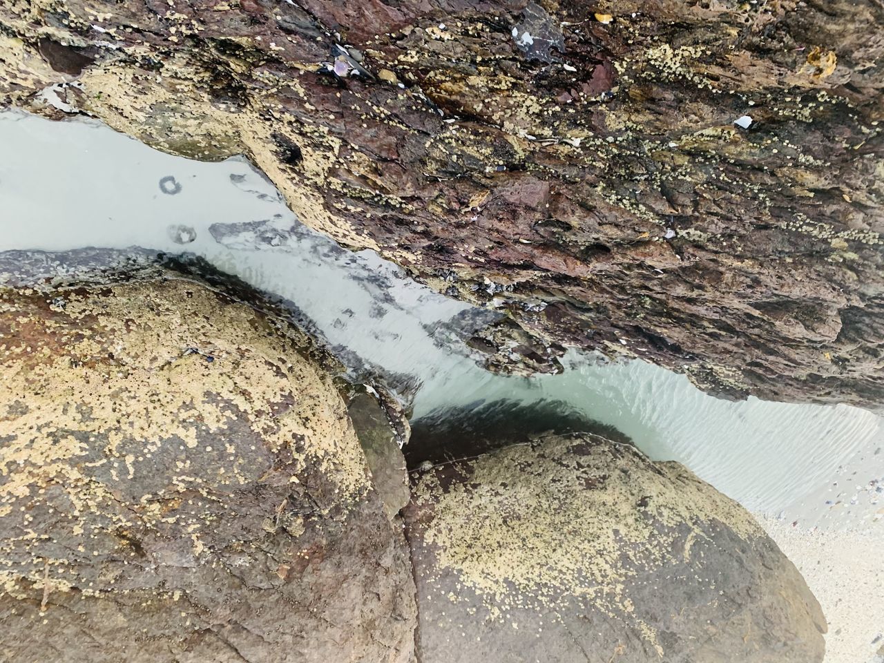 rock, water, soil, geology, nature, high angle view, day, no people, beach, land, outdoors, sand, sea, beauty in nature, close-up, textured, tranquility, wet