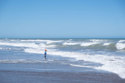 Scenic view of sea against clear blue sky