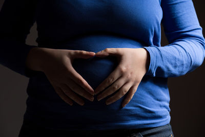 Midsection of woman touching hair