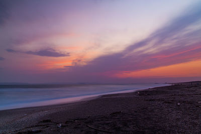 Scenic view of sea against romantic sky at sunset