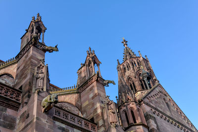 Low angle view of historic building against clear blue sky