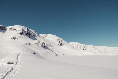 Snowcapped mountains against clear sky