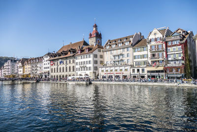 Buildings in city against clear sky