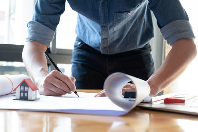 Midsection of man working on table
