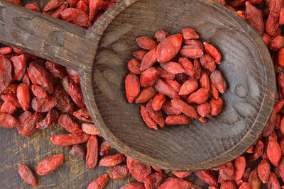 Close-up of goji berries on wooden spoon