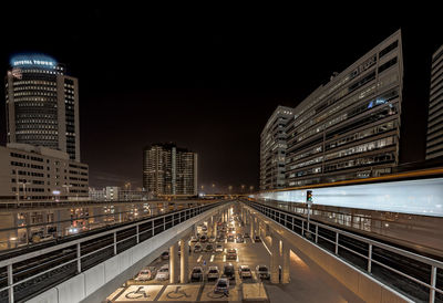 Illuminated city against sky at night