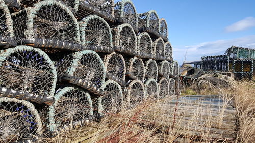 Stack of commercial fishing nets on field