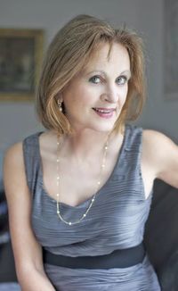 Portrait of smiling well-dressed senior woman sitting at home