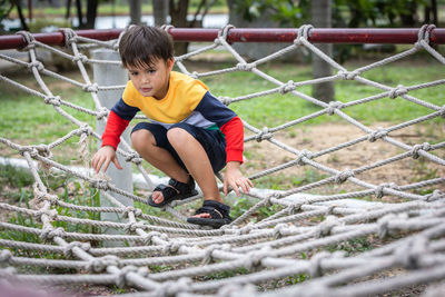 Full length of boy playing on field