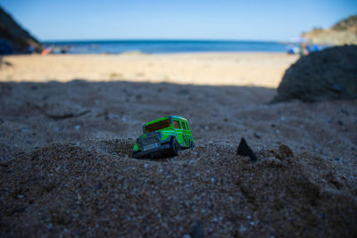 Close-up of toy car on sand at beach