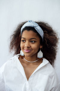 Portrait of smiling young woman wearing mask