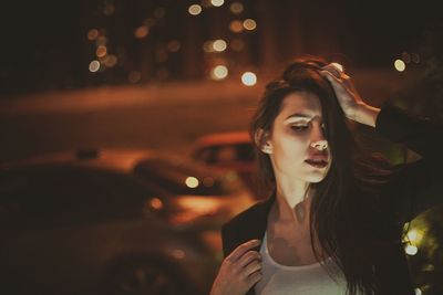 Low angle view of woman standing at night