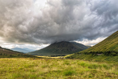 Scenic view of mountains against cloudy sky