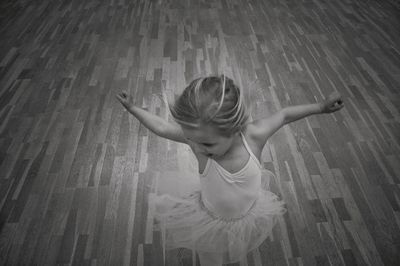 High angle view of girl dancing on hardwood floor