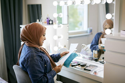 Woman sitting at dressing table