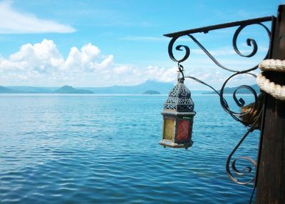 View of calm blue sea against mountain range