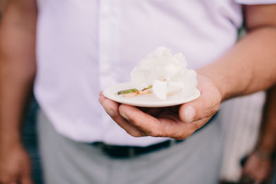 Midsection of man holding ice cream