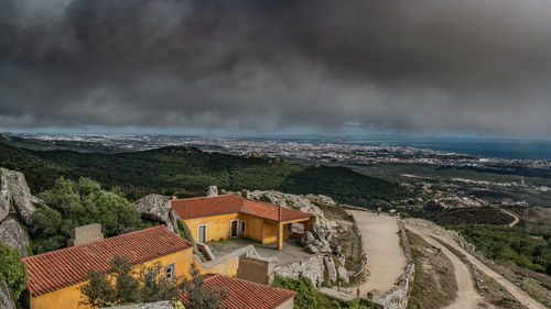 High angle view of buildings by sea against sky