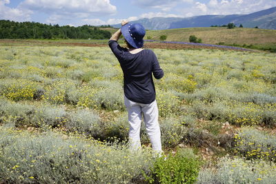 Rear view of man standing on field