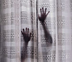Woman touching curtain at home