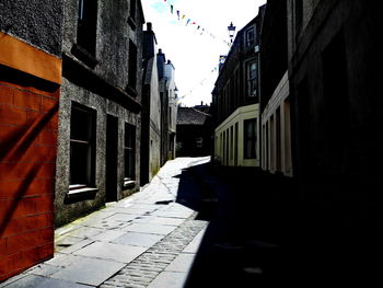 Street amidst buildings against sky