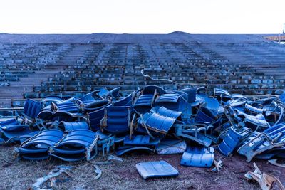 Chairs on beach against clear sky