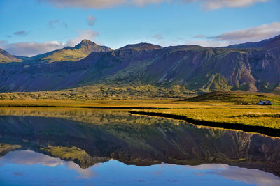 Scenic view of lake and mountains against sky