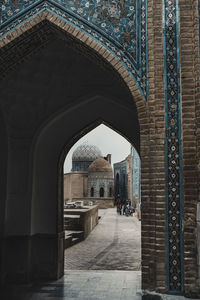 Entrance of historic building. view of the ancient city through the arch. group of mausoleums.