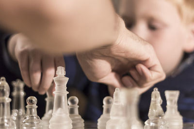 Close-up of people playing chess