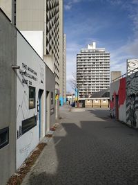 Street amidst buildings against sky in city