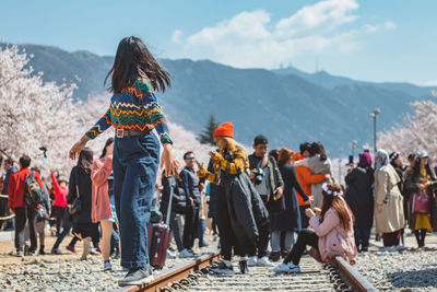 Rear view of people standing on mountain road