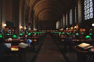 Empty chairs and tables in illuminated building