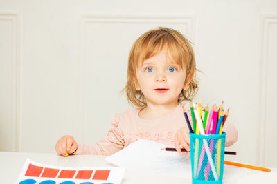 Portrait of young woman using laptop at home