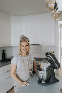 Smiling woman in kitchen