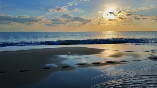 Scenic view of sea against sky at sunset