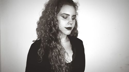 Close-up of young woman against white background