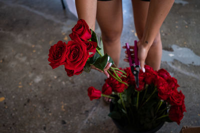 Midsection of woman holding rose bouquet